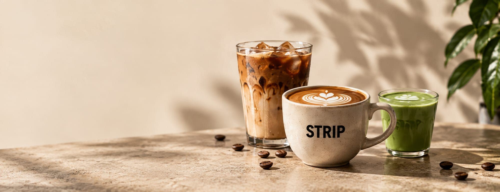 An iced coffee, a STRIP latte and a matcha side by side
